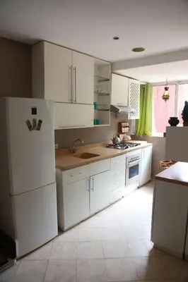a kitchen with white cabinets and a white refrigerator at Appart Bin Elouidane in Bine el Ouidane