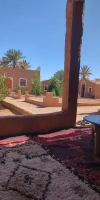 a view of a room with a rug and a table at Kasbah Desert Camp in Mhamid