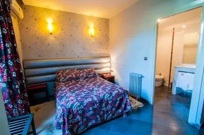 a bedroom with a bed in a room at Hotel De La Paix in Fès