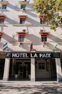 a hotel laaza sign in front of a building at Hotel De La Paix in Fès