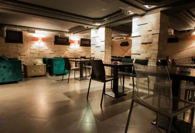 a restaurant with tables and chairs in a room at Hotel De La Paix in Fès