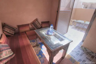 a room with a table with a bottle on it at La Porte du Dades in Boumalne