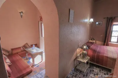a living room with a couch and a table at La Porte du Dades in Boumalne