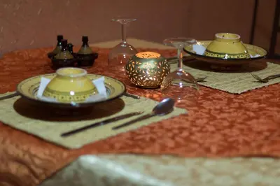 a table with two plates and chopsticks on a table at La Porte du Dades in Boumalne
