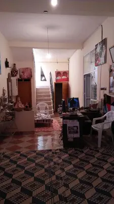 a living room with a couch and a table with a laptop at gîte les jardins in Goulmima