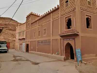 an old building on a street in an old town at Riad Berbère Boutaghrar in Bou Tharar