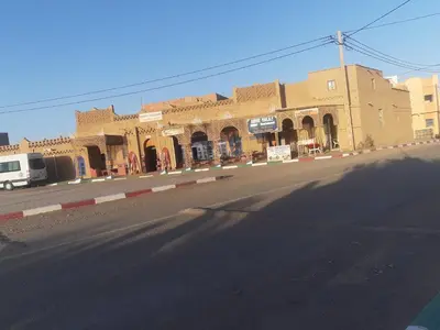 a building on the side of a street at Appartement belkacem in Merzouga