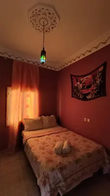 a bedroom with a bed with two shoes on it at Myhouse Todgha in Tinerhir