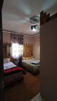 a bedroom with two beds in a room with a ceiling at Myhouse Todgha in Tinerhir