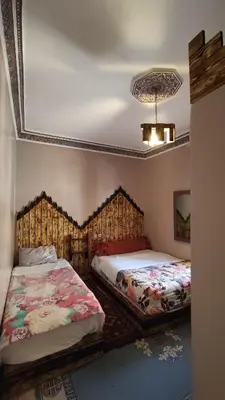 a bedroom with two beds and a ceiling at Myhouse Todgha in Tinerhir