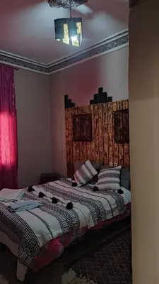 a bedroom with a bed in a room with at Myhouse Todgha in Tinerhir