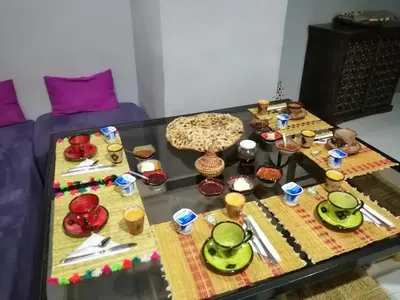 a coffee table with a bunch of food on it at Maison d'hôtes Dar El Nath in Ouarzazate