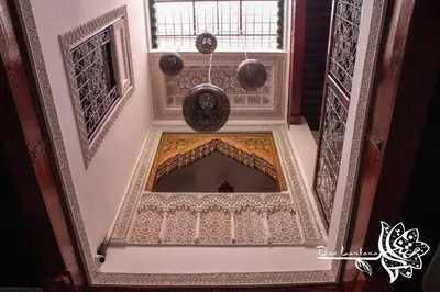 an ornate ceiling in a building with a window at Dar Lantana in Fès