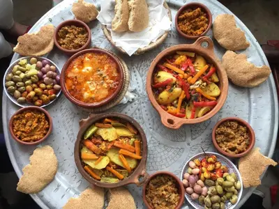 a table topped with bowls of different types of food at Dar Sunrise Fes in Fès