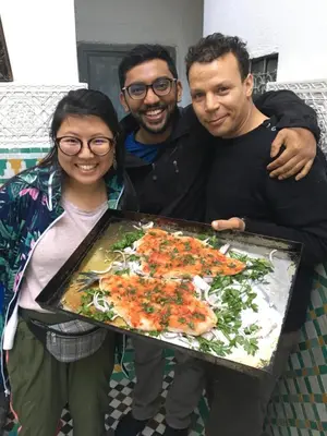 a group of three people holding a tray of food at Dar Sunrise Fes in Fès