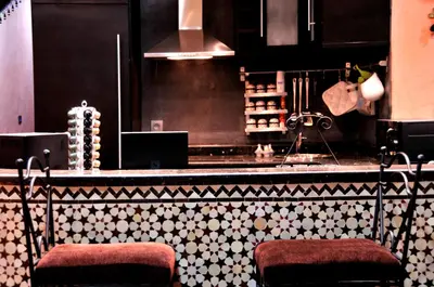 a kitchen with a counter with two stools at Luxury Riad Saad Fes- Apart in Fès