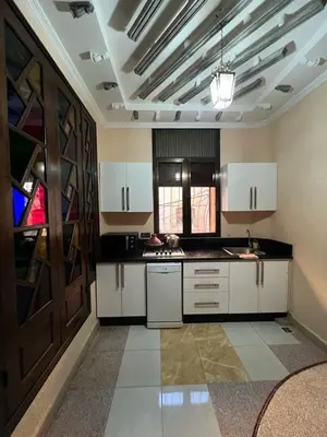 a large kitchen with white cabinets and a ceiling at 