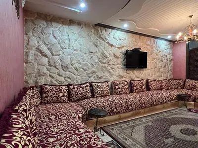 a couch in a room with a stone wall at 
