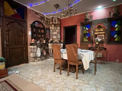 a dining room with a table and stained glass windows at 