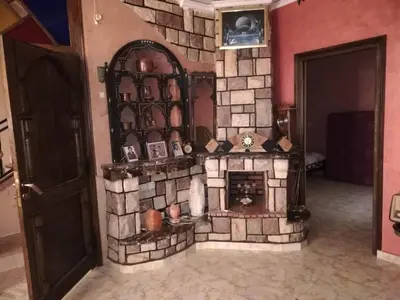 a fake stone fireplace in a room with a door at 