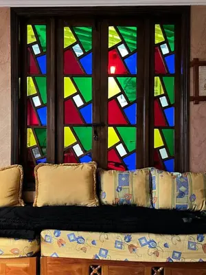 a couch sitting in front of a stained glass window at 