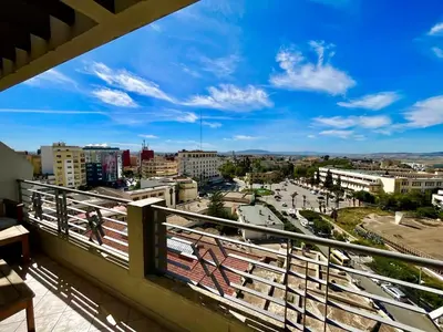 a view of a city from a balcony at Hotel Malta in Meknès