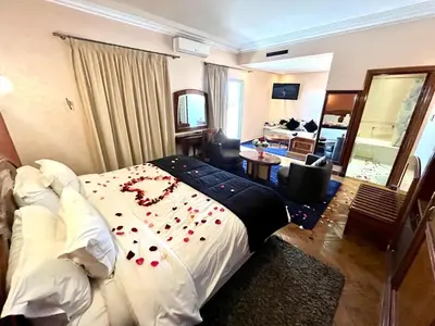 a hotel room with a bed with a necklace on it at Hotel Malta in Meknès