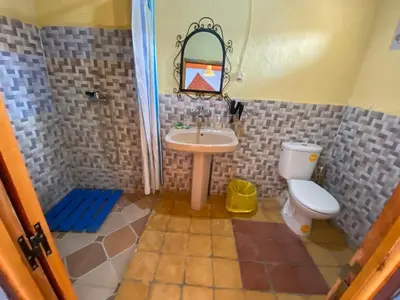 a bathroom with a sink and a toilet at Auberge Kasbah Des Dunes in Merzouga