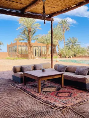 a living room with a couch and a table at Kasbah Aitisfoul in Tagounite