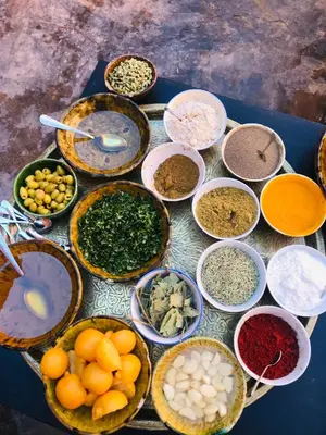 a table with many bowls of different types of ingredients at Kasbah Aitisfoul in Tagounite