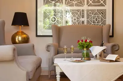 a living room with a table with glasses and a couch at Palais de l'O - Maison d'hôtes in Marrakech