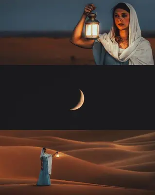 a woman in a desert with a light and a man holding a lantern at Royal Luxury Camp in Merzouga