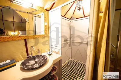 a bathroom with a sink and a shower at Sahara Happy Camp in Merzouga