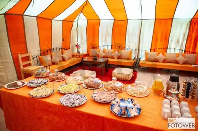 a table with plates of food on it in a tent at Sahara Happy Camp in Merzouga