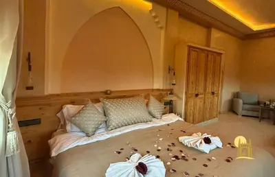 a bedroom with a large bed with flowers on it at Sbai Palace in Mhamid
