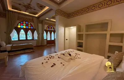 a bedroom with a bed with rose petals on it at Sbai Palace in Mhamid