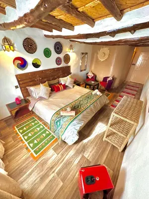 a bedroom with a large bed in a room at Kasbah El Hajja in Aït Ben Haddou