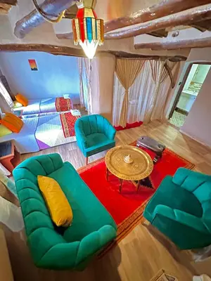 a room with a couch and chairs and a table at Kasbah El Hajja in Aït Ben Haddou