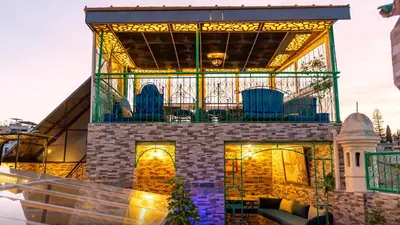 a building with chairs on top of it at Riad Dar El Ouedghiri in Fès