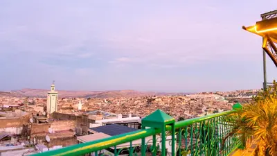 a view of a city from a balcony at Riad Dar El Ouedghiri in Fès