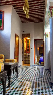 a living room with a couch and a table at Riad Dar El Ouedghiri in Fès