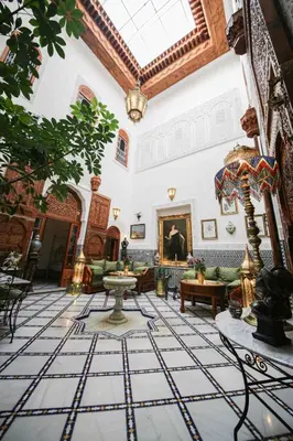 a living room with a large room with a fireplace at Dar Dalila Fes in Fès