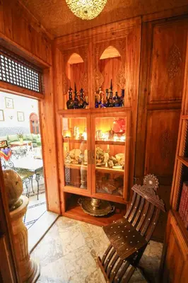 a kitchen with a glass cabinet with food in it at Dar Dalila Fes in Fès
