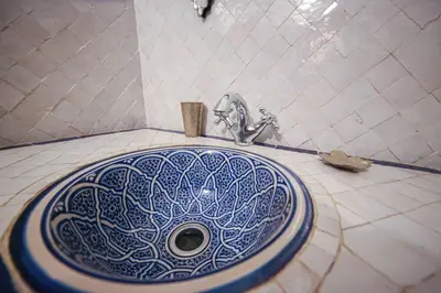 a bathroom sink with a blue and white pattern on it at Dar Dalila Fes in Fès