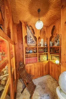 a room with wooden cabinets and a chair in it at Dar Dalila Fes in Fès