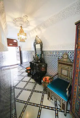a room with a chair and a tiled floor at Dar Dalila Fes in Fès