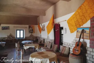 a room with a room with a guitar on the wall at Sahara Desert Experience camp in Merzouga