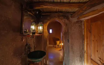 a hallway in an old house with a room with at Kasbah Tebi in Aït Ben Haddou