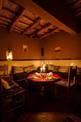 a living room with a table and a couch at Kasbah Tebi in Aït Ben Haddou