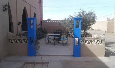 two blue mailboxes in front of a building at Kasbah Tamariste in Merzouga